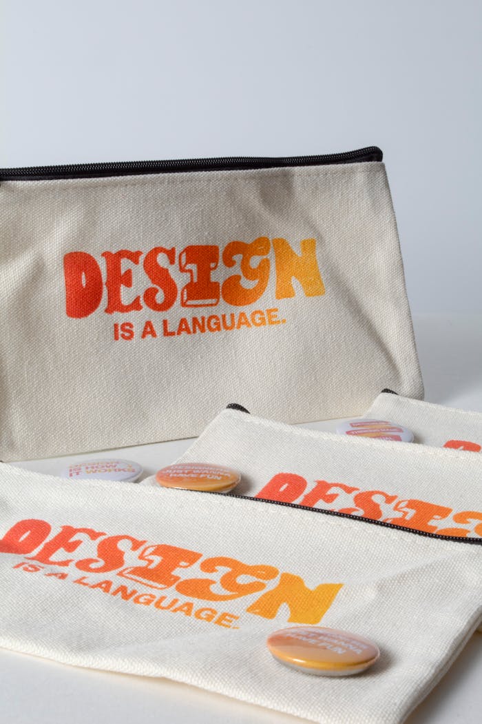 Mastering the First Impression: Your intriguing post title goes here Stylish canvas pouches featuring design quotes and colorful buttons against a minimalist backdrop.